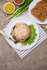 Delicious chicken aspic on a plate on concrete table