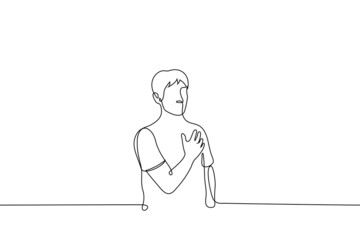 man holding his heart - one line drawing vector. concept male patriot stands listening to anthem of his country, heartache, gesture of touching or tenderness