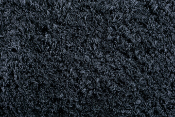 Carpet texture background. Black gray cotton carpet for floor coverings. Material for interior design and decoration of living rooms