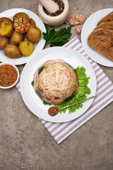 Delicious chicken aspic on a plate on concrete table