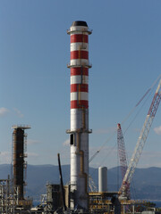 Fototapeta na wymiar Refinery smokestack in Corinth, Greece