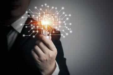 Businessman holding light bulb. Concept of ideas with innovation and inspiration.