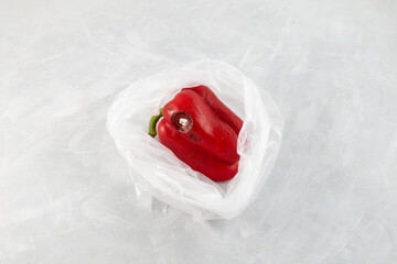 Moldy wrinkles red pepper in plastic bag. Concept - Improper food storage. Reduction of organic waste