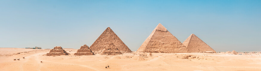 sweeping panorama of the entire desert and all three of the Great Pyramids at Giza, Egypt nearby on...