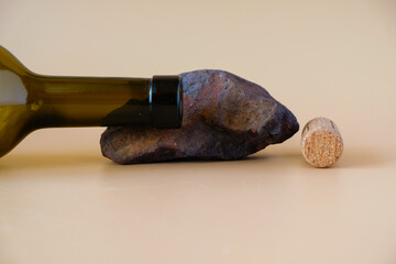 Wine cork and the neck of an empty bottle on an Ocher stone. Languedoc Roussillon wine region...