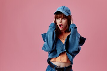 pretty woman in a cap and denim jacket posing color background unaltered