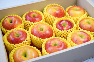 Fresh Red apple in packaging ready to sell, US. Red Envy apple in the paper box.