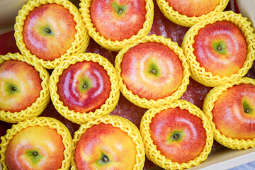 Fresh Red apple in packaging ready to sell, US. Red Envy apple in the paper box.