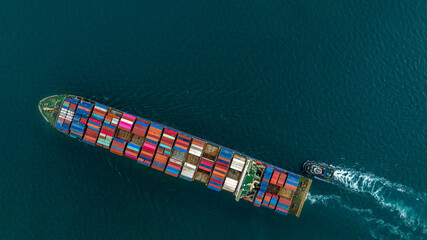 Aerial top view of cargo ship carrying container and running for export  goods  from  cargo yard...