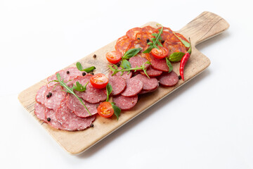 Various meat snacks on the board. On white background.