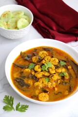 Tangy and spicy Shrimp curry. Tiny prawns curry made using dried mango and Indian spices. garnished with coriander and served with cucumber slices. Copy space.