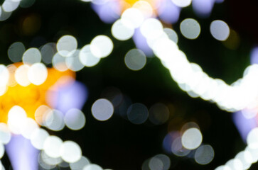 festive bright background with defocused lights of New Year or Christmas garlands with bokeh effect