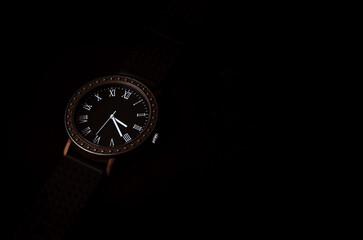 Men's accessory. Men's watches on a dark background with Roman numerals. Stock photo