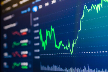 Stock market success chart on the screen. Selective focus.