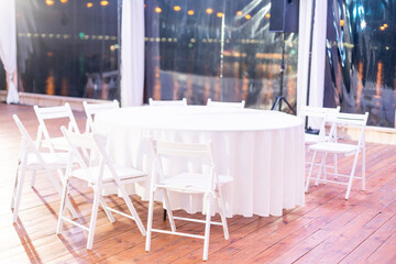 Dinner table, white empty round party table.