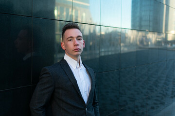 Young businessman standing at the city.
