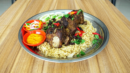 Indian beef rib biryani served on a tray on the table. Selective focus & Free Photo