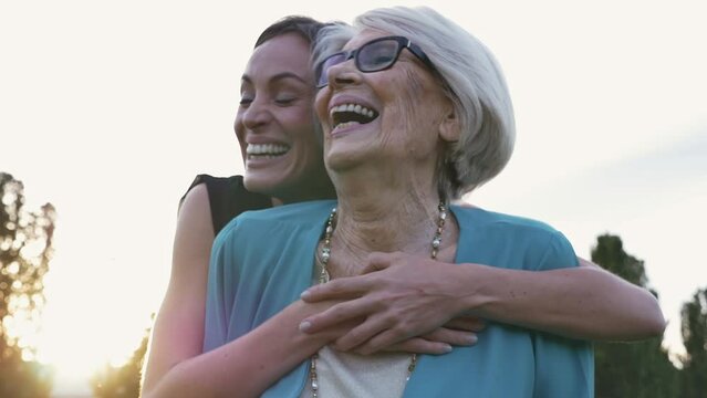 Cinematic and storytelling video of a granddaughter and her grandmother spending time together. Young woman visiting her grandmother. Concept about health care, family and lifestyle.