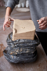 Female ceramist working in pottery studio. Ceramist's Hands Dirty Of Clay. Process of creating pottery. Master ceramist works in her studio
