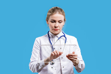 A female doctor looks into a tablet on a blue background. Chief Physician. Hospital. Analyzes from...