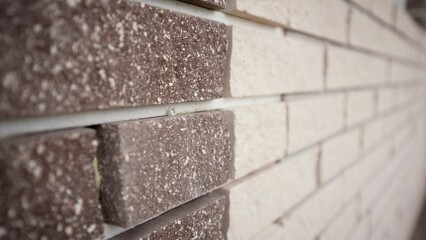 The wall is made of white and brown bricks. Brick background. Empty horizontal part of the wall....