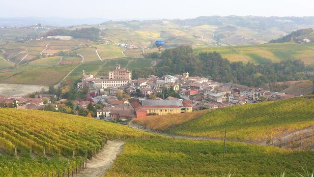 Beautiful hills and vineyards during fall season surrounding Barolo village. In the Langhe region, Cuneo, Piedmont, Italy.