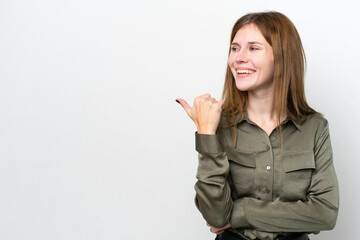 Young English woman isolated on white background pointing to the side to present a product