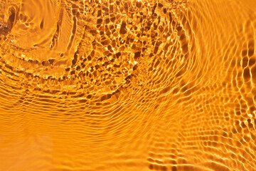 Banner or background for advertising cosmetics with orange water spills. Natural sunlight and shade. Beautiful bursts and glare. Summer mood. Minimal style.