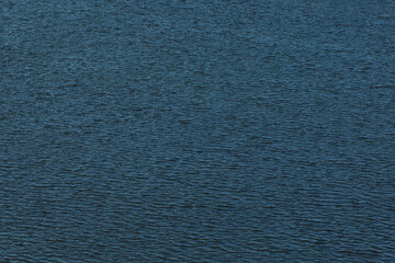 Texture of river or sea water. Aerial view and top view of blue-colored river.
