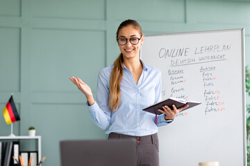 Studying German online. Cheerful female teacher giving online foreign language lesson, using laptop