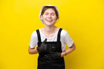 Young English fisherwoman isolated on yellow background smiling a lot
