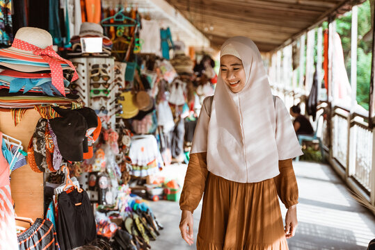 beautiful muslim asian woman wearing scarf walking
