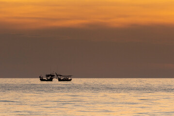 Silhouette of boats on the sea during sunset