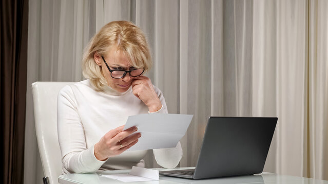 Blonde Long-haired Dame With Bangs And Light Natural Makeup In Turtleneck Reads Letter With Bad News About Relative Death And Feels Stressed.