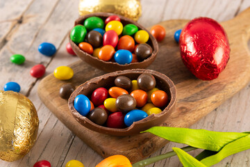 Colorful chocolate Easter eggs on wooden table	