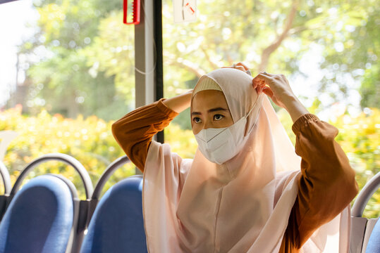 Muslim Woman With Face Mask Commuting By Public Transportation.