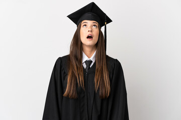 Teenager Brazilian university graduate over isolated white background looking up and with surprised...