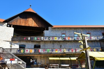 Žužemberk, Slovenia - September 2 2021: Inside of the Žužemberk castle, Suha Krajina, Dolenjska, Slovenia with coats of arms on a wooden fence on the balcony