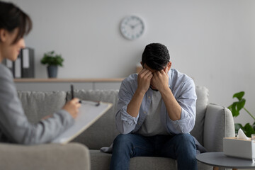Psychotherapy, treatment of depression concept. Stressed middle eastern guy having session at...