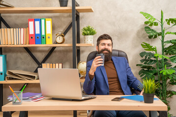 happy freelancer use online computer communication at office holding coffee, business communication.