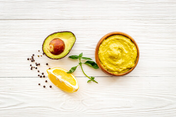 Bowl of guacamole dip with avocado and lime. Homemade guacamole concept