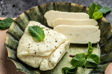Traditional slices of cyprus halloumi cheese with mint. healthy eco food. Food recipe background. Close up - obrazy, fototapety, plakaty