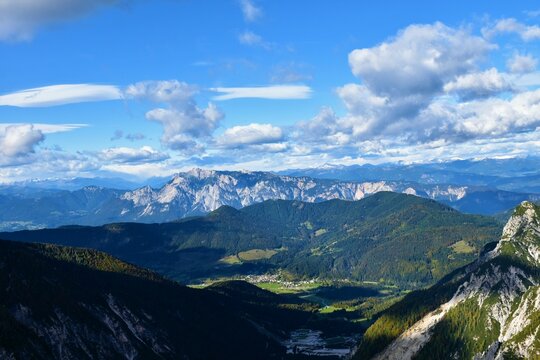 View of Dobrac mountain in Carinthia, Austria and forest covered hill in front with the town of Ratece in Slovenia bellow