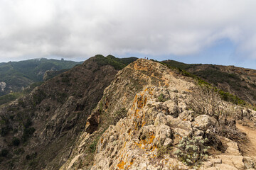Fototapeta na wymiar Hikers on top of Montana Tafada in Anaga mountain range, Tenerife, Spain