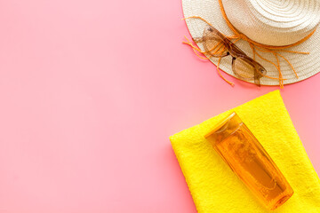 Skin care with sunscreen. Sun lotion and suglasses with straw hat