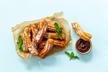 Treat churros with sugar served on baking paper