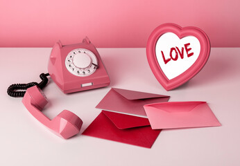 Valentines day concept. Retro phone with handset off standing on table with heart-formed mirror and...