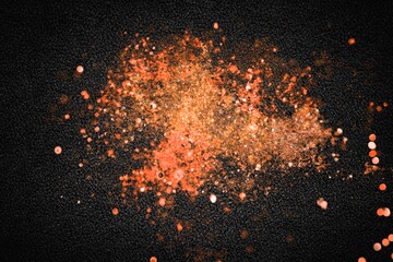 Explosion of various spices on dark background