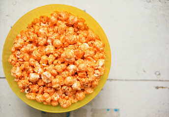 A plate of sweet popcorn on an old white table