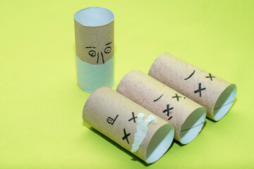 Stylized doctor and sick people from empty toilet paper rolls. Concept - problems and diseases associated with the intestines and their treatment. Food poisoning and bacterial diseases.